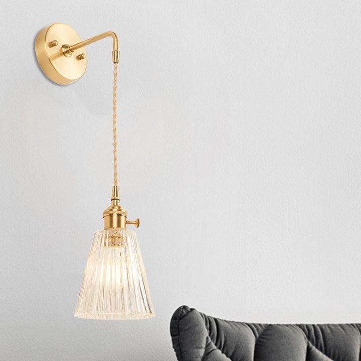 Lisslune | A wall light with a bulb and conical shade made of clear, textured glass, industrial bedroom wall light fixture