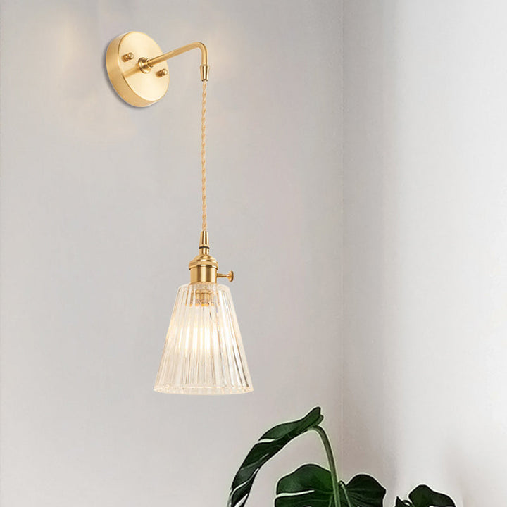 Lisslune | A wall light with a bulb and conical shade made of clear, textured glass, industrial bedroom wall light fixture