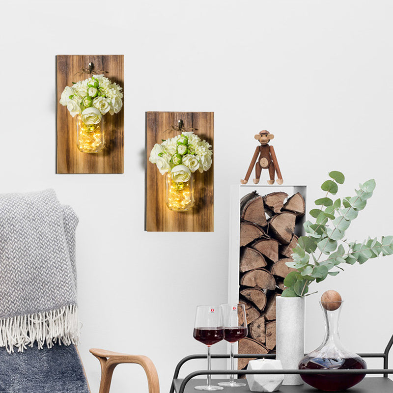 Skørter | Modern white rose string lamp with clear glass container and wooden back panel