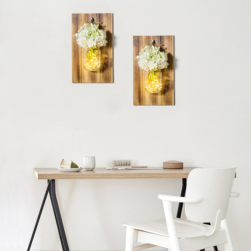 Skørter | Modern white rose string lamp with clear glass container and wooden back panel