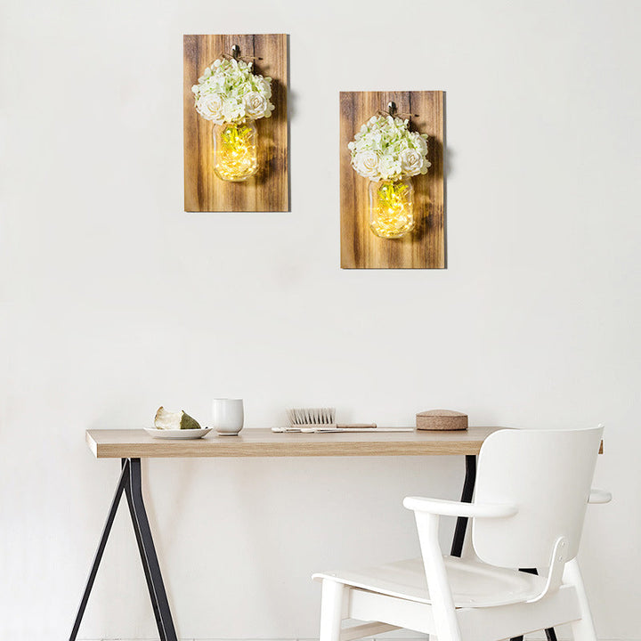 Skørter | Modern white rose string lamp with clear glass container and wooden back panel