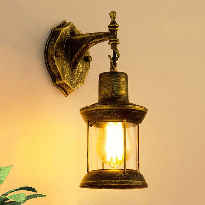 Lisslune | An E27 wall light with a petroleum shade made of clear glass Traditional outdoor wall light in antique bronze