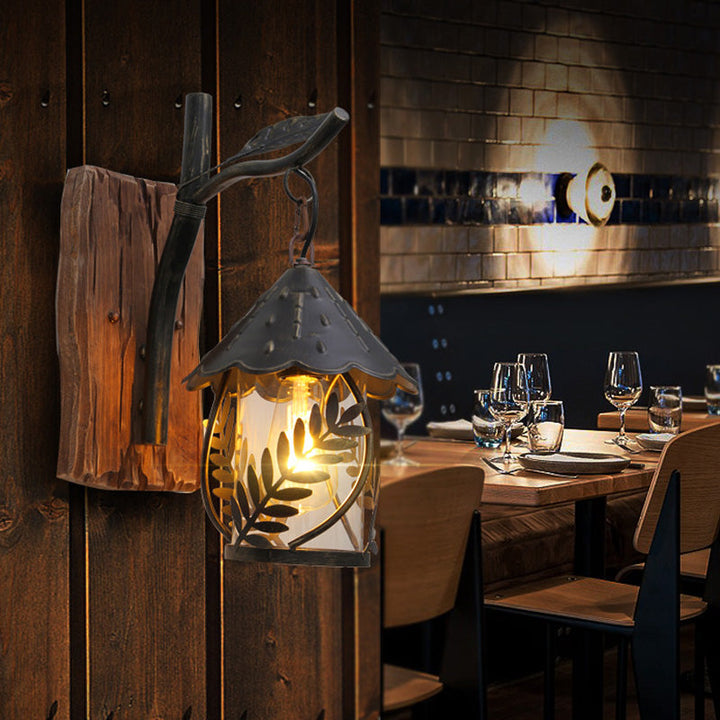 Lisslune | A wall lamp with a glass bulb and cylindrical shade made of clear glass, industrial wall lamp for the living room with leaf branch in black