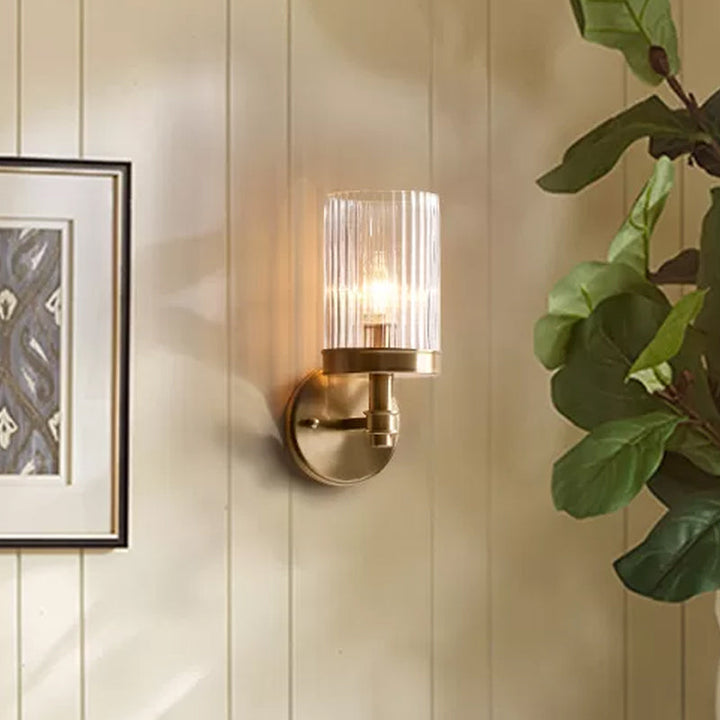 Skørter | 1-Light Wall Mount Lamp Traditional Cylinder Transparent Glass Wall Light in Brown/Gold above the Bed
