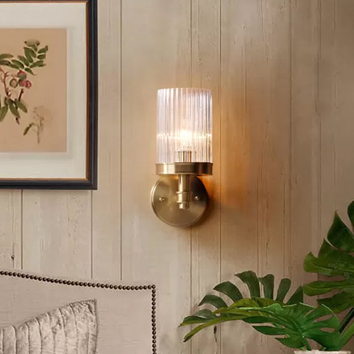 Skørter | 1-Light Wall Mount Lamp Traditional Cylinder Transparent Glass Wall Light in Brown/Gold above the Bed