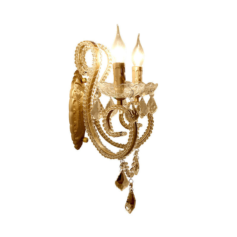 Skørter | Traditional curved arm wall light metal wall mounted lights in brass with hanging crystals