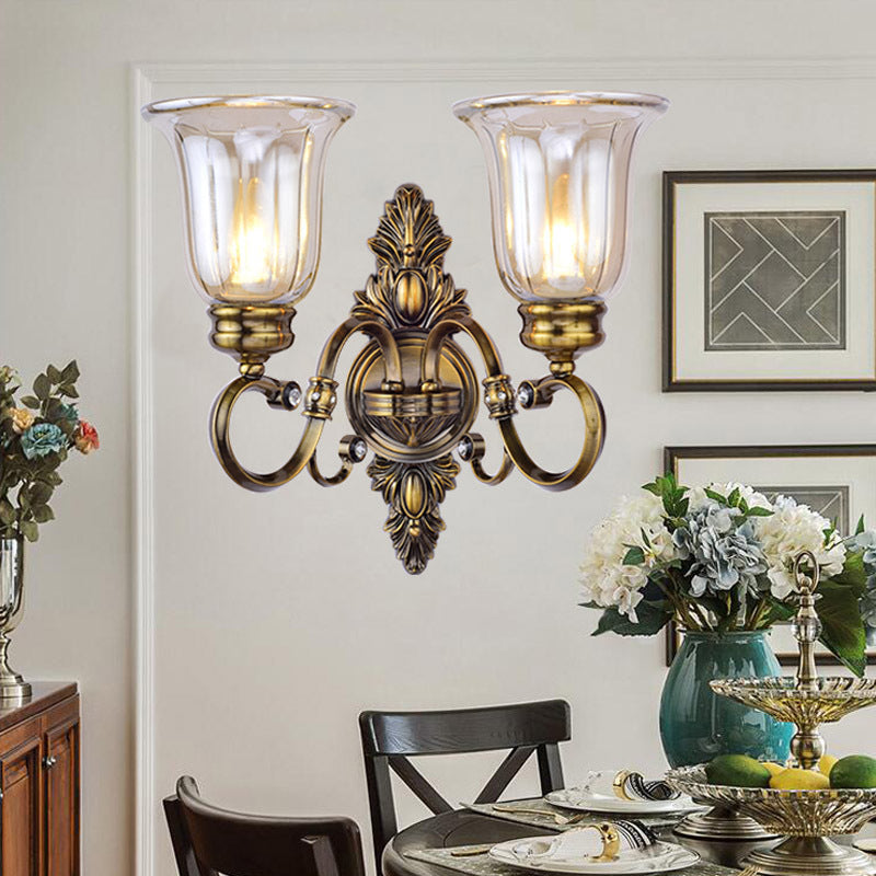 Skørter | 1/2-Light Clear Glass Wall Light Traditional Bronze Bell Shade Dining Room Wall Lamp with Curved Arm
