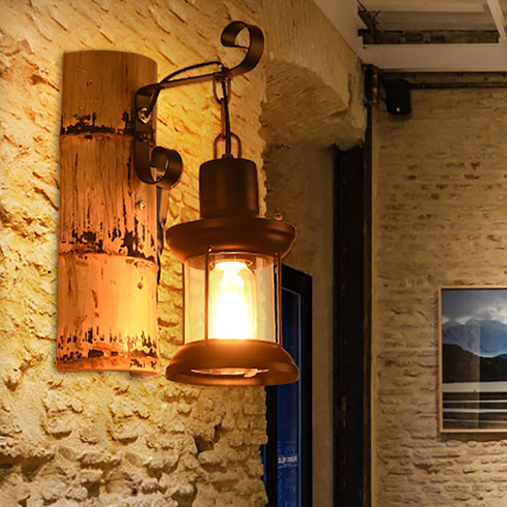 Lisslune | A wall lamp with a clear glass lantern in industrial style, wall lamp for the dining room in black with a bamboo backplate