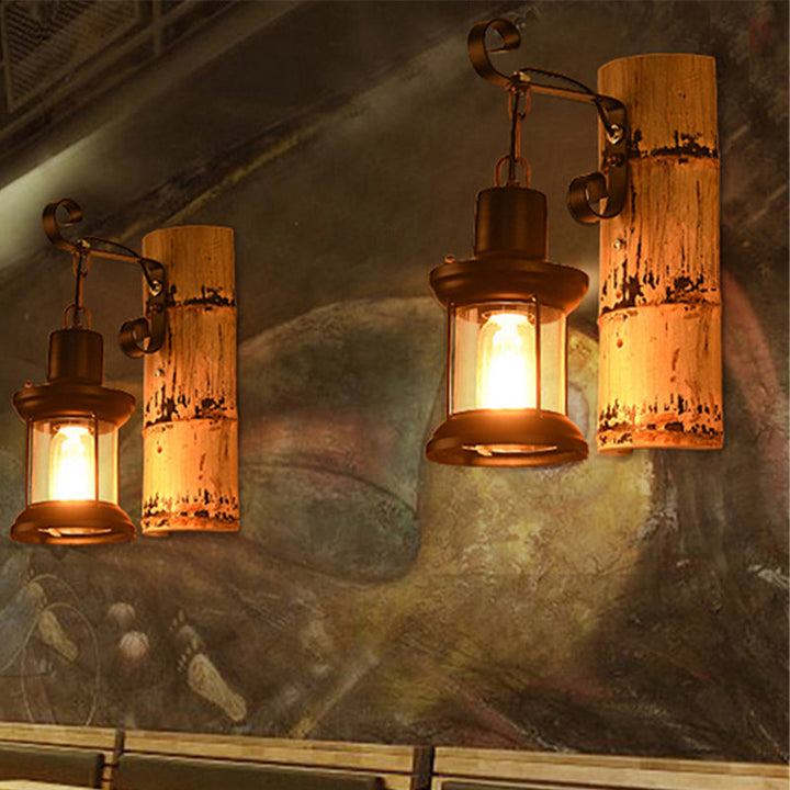 Lisslune | A wall lamp with a clear glass lantern in industrial style, wall lamp for the dining room in black with a bamboo backplate
