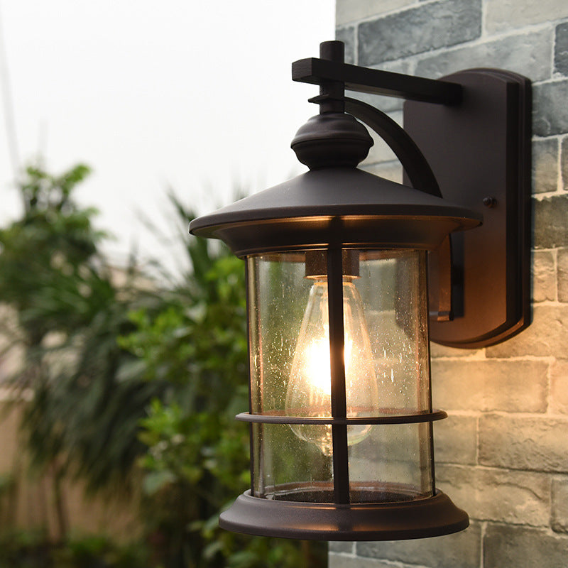 Skørter | Clear Seeded Glass Cylinder Wall Lamp Lodges 1-Bulb Outdoor Wall Mounted Lamp in Black/Brown for Garden