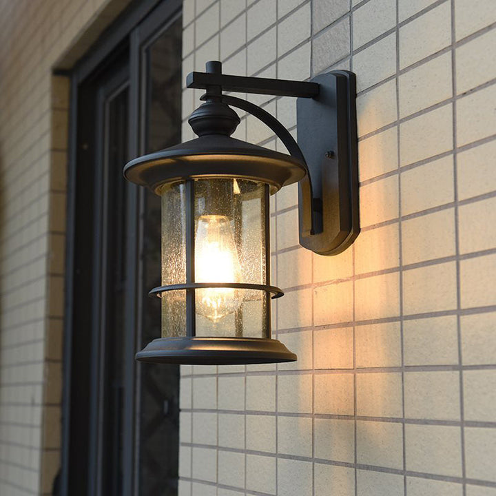 Skørter | Clear Seeded Glass Cylinder Wall Lamp Lodges 1-Bulb Outdoor Wall Mounted Lamp in Black/Brown for Garden