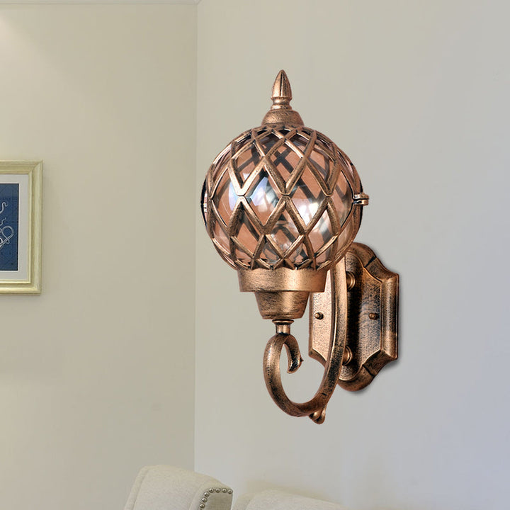 Skørter | Clear Glass Globe Wall Light Lodges 1-Bulb Outdoor Wall Light in Brass with Cage