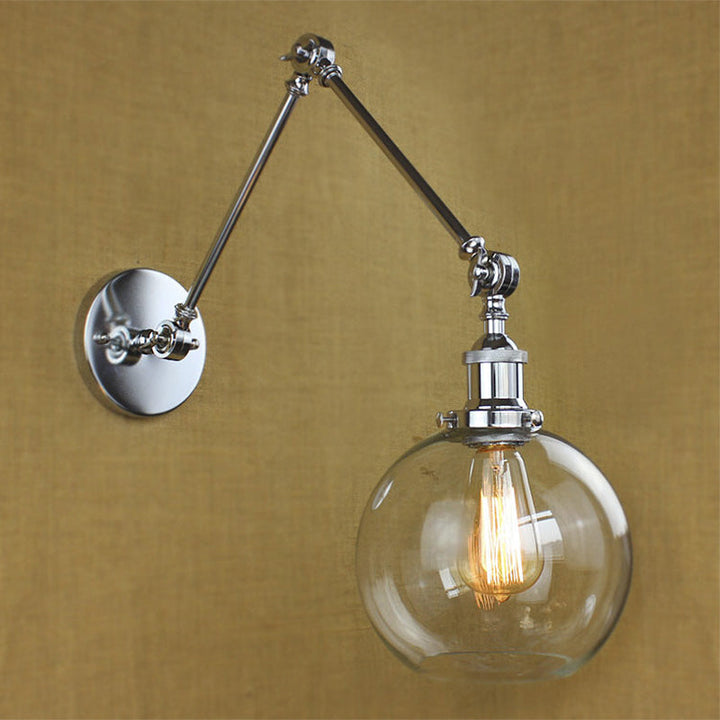 Lisslune | A wall lamp with a glass globe shade, clear glass, industrial dining room wall light with swivel arm