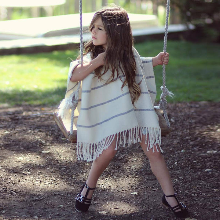 Women's beach poncho with fringed hem and striped design