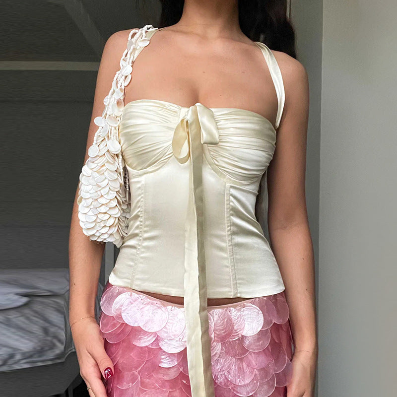 Women's satin top with playful ruffle detail and decorative tie band