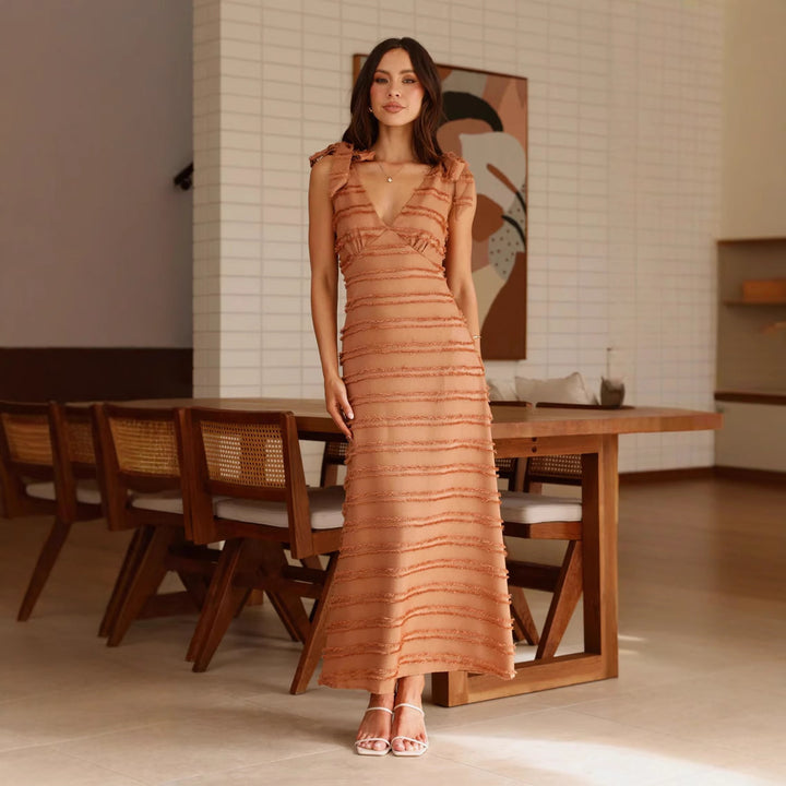 Ladies maxi dress with elegant draping design and ruffle accents