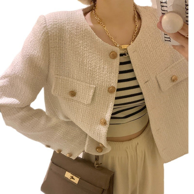 Women's short blazer with elegant gold buttons and modern cut