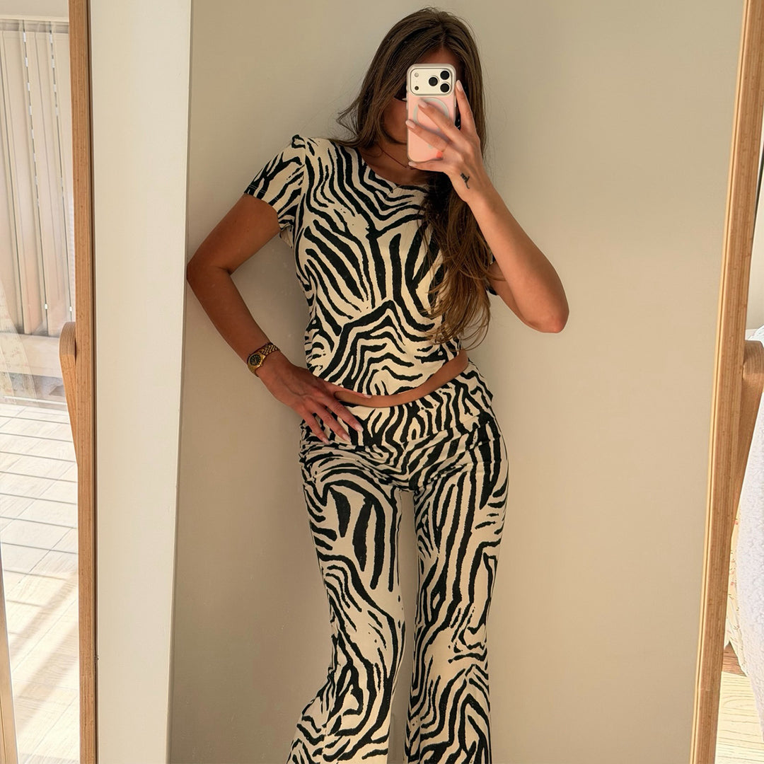 Women's set made of short-sleeved top and flared pants with zebra pattern