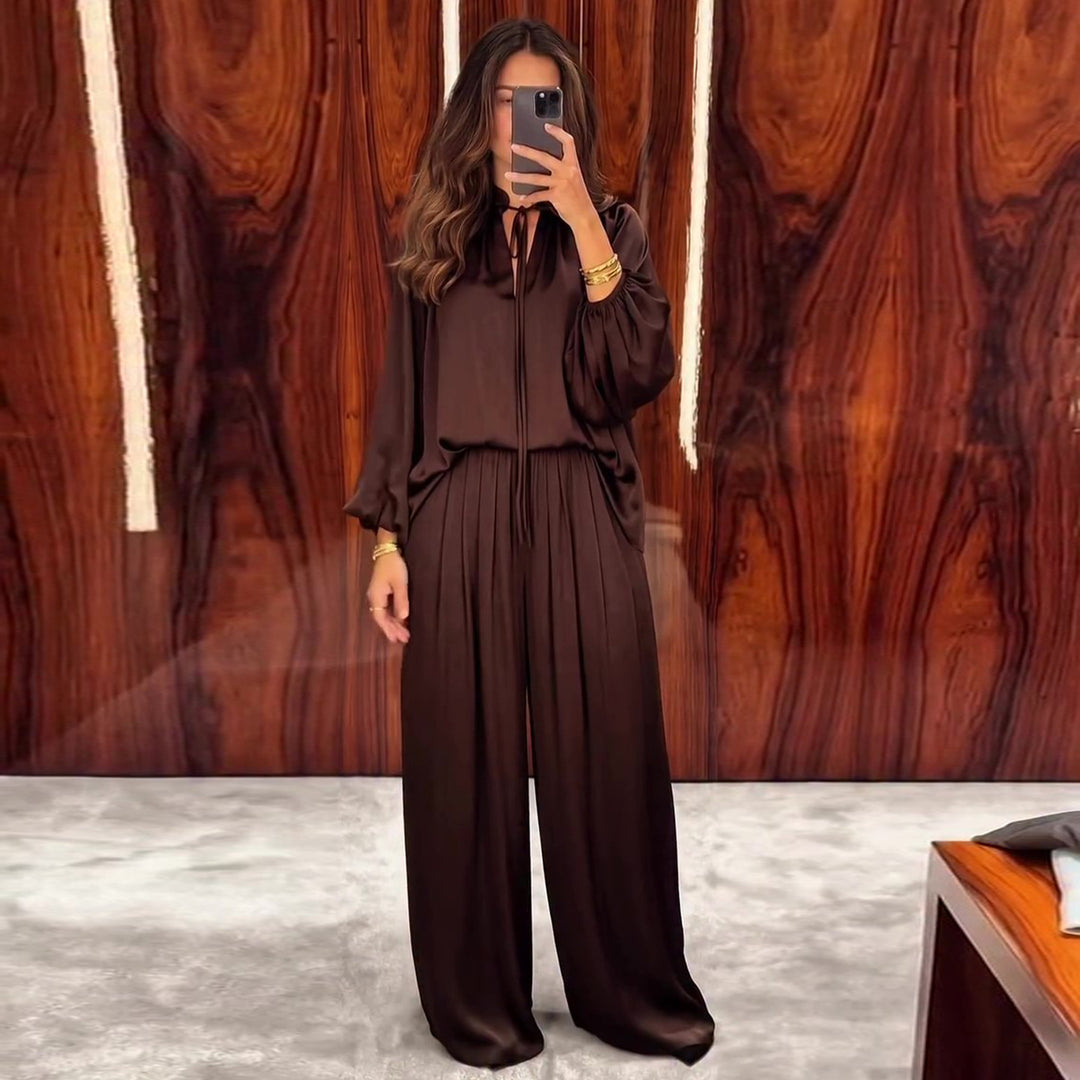 Women's elegant two-piece set made of flowing material with refined pleats and a wide cut.