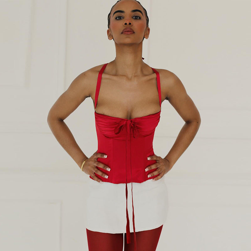 Women's satin top with playful ruffle detail and decorative tie band
