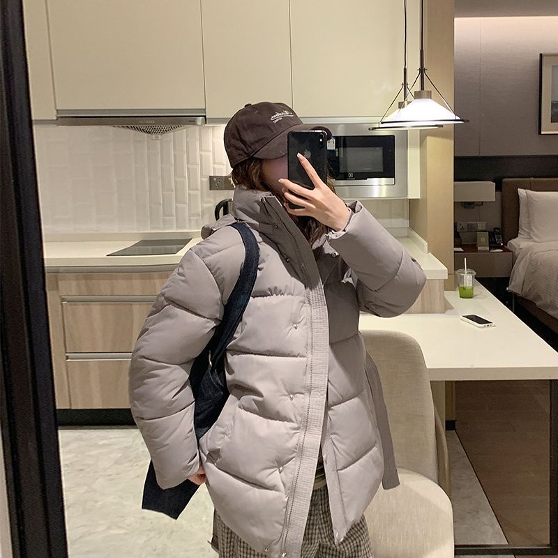 Women's quilted winter jacket with high collar and side pockets