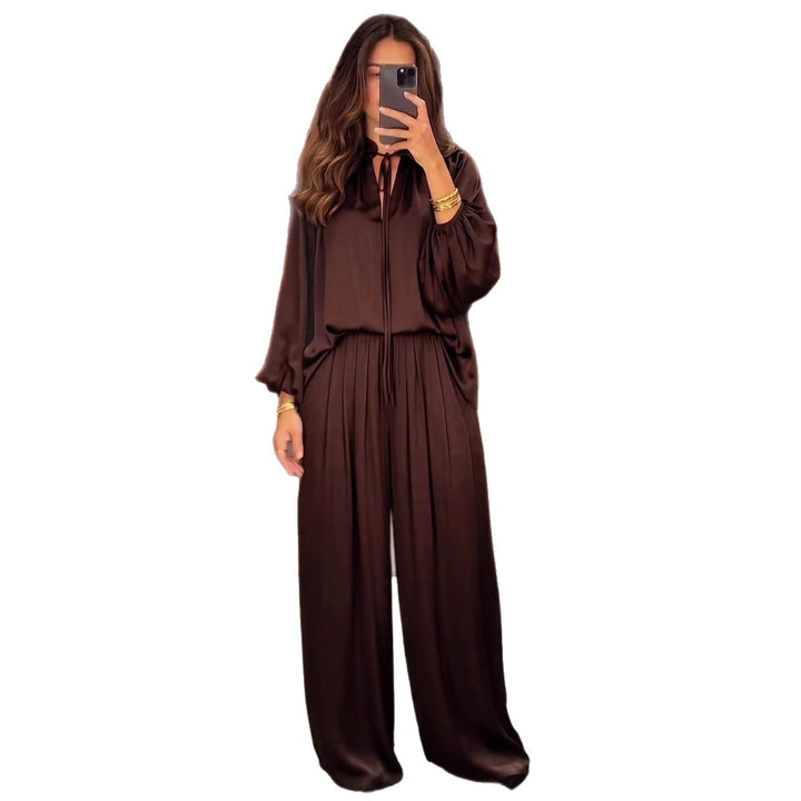 Women's elegant two-piece set made of flowing material with refined pleats and a wide cut.