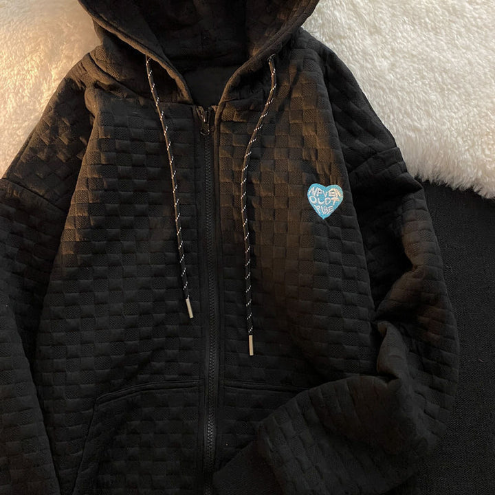 Women's hoodie jacket made of structured material with practical pockets and fashionable design