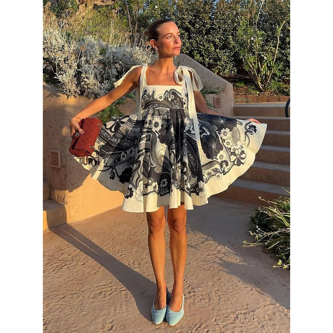 Women's summery mini dress with playful pattern mix and flowy cut Lune London