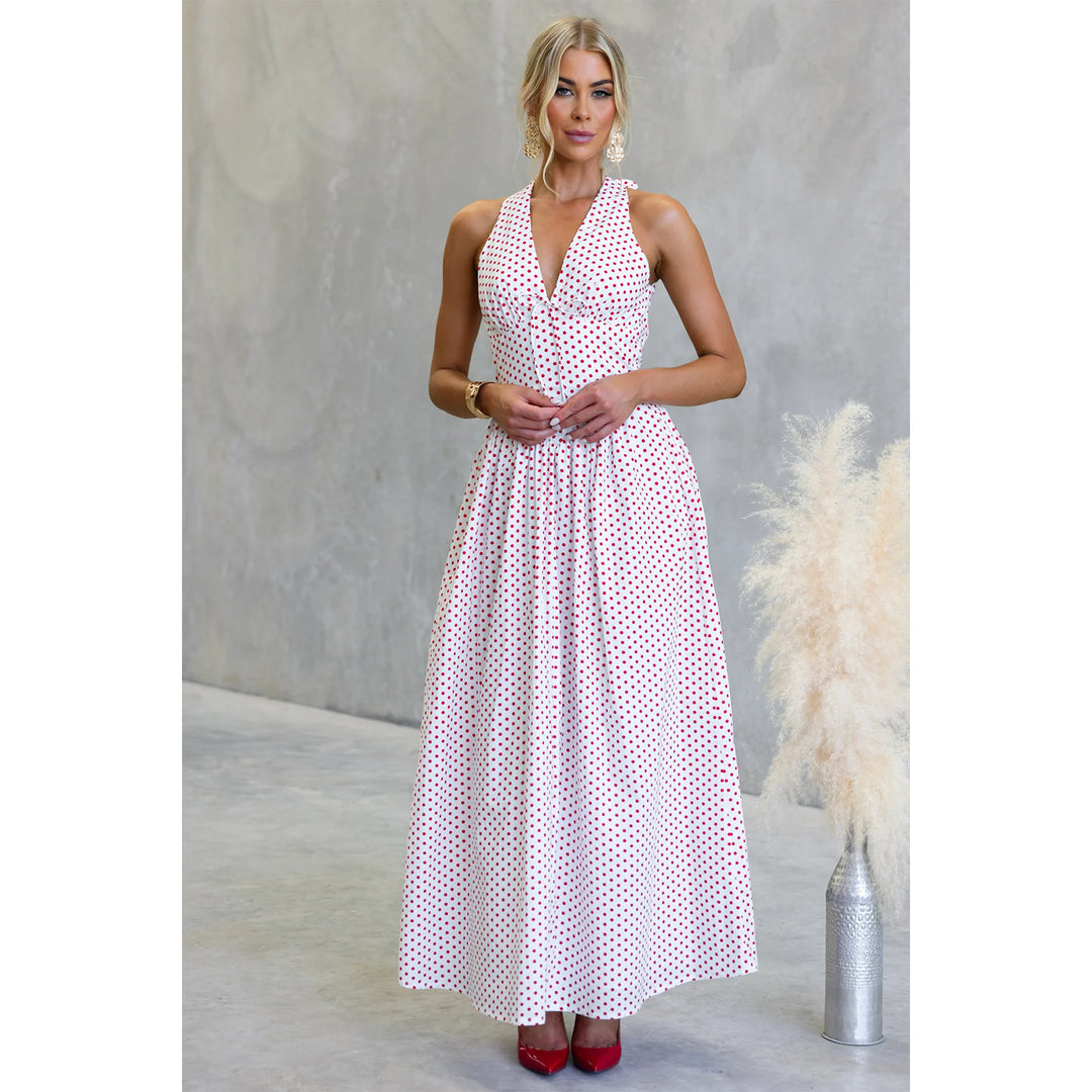 Women’s maxi dress with deep V-neckline and playful polka dot pattern