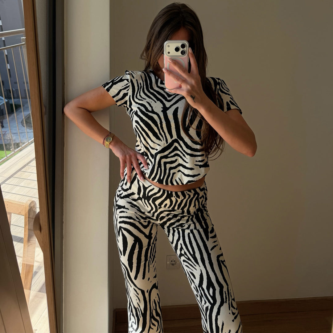 Women's set made of short-sleeved top and flared pants with zebra pattern