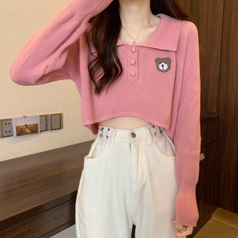 Women Cropped Pullover with a one-button closure and unicorn emblem
