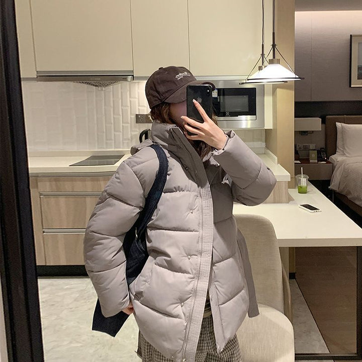 Women's quilted winter jacket with high collar and side pockets