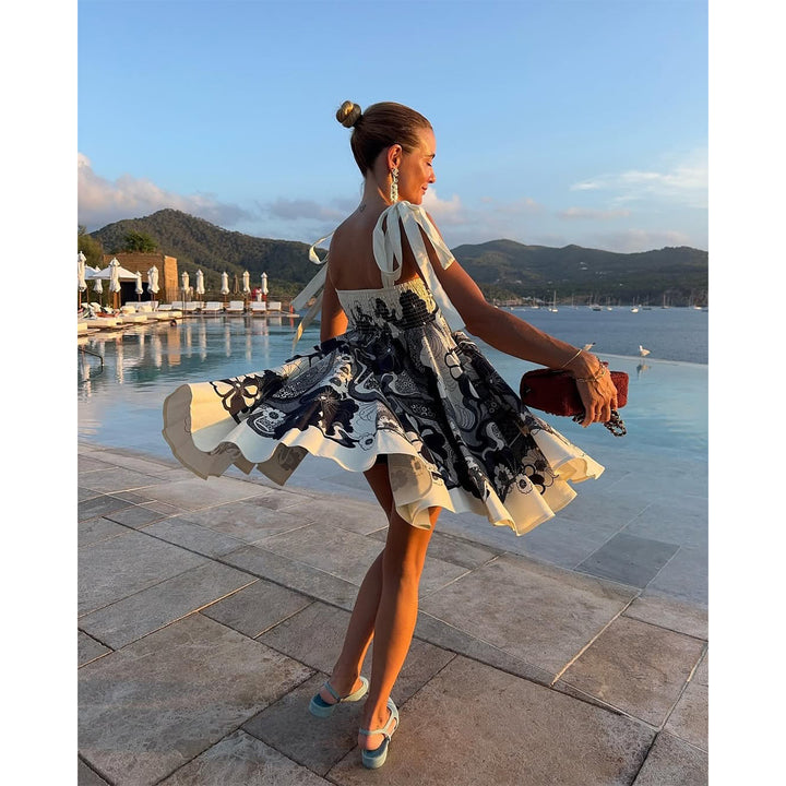 Women's summery mini dress with playful pattern mix and flowy cut Lune London