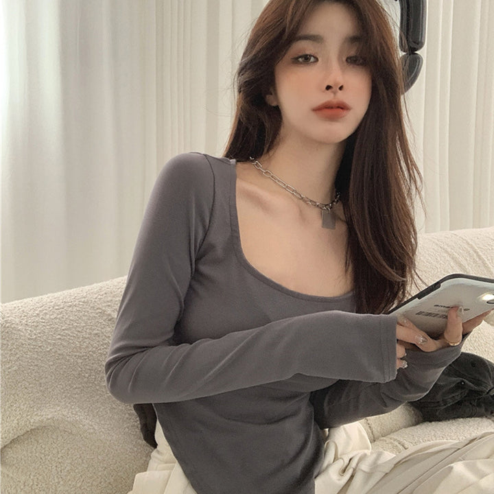 Women's long-sleeved top with elegant neckline and asymmetric design
