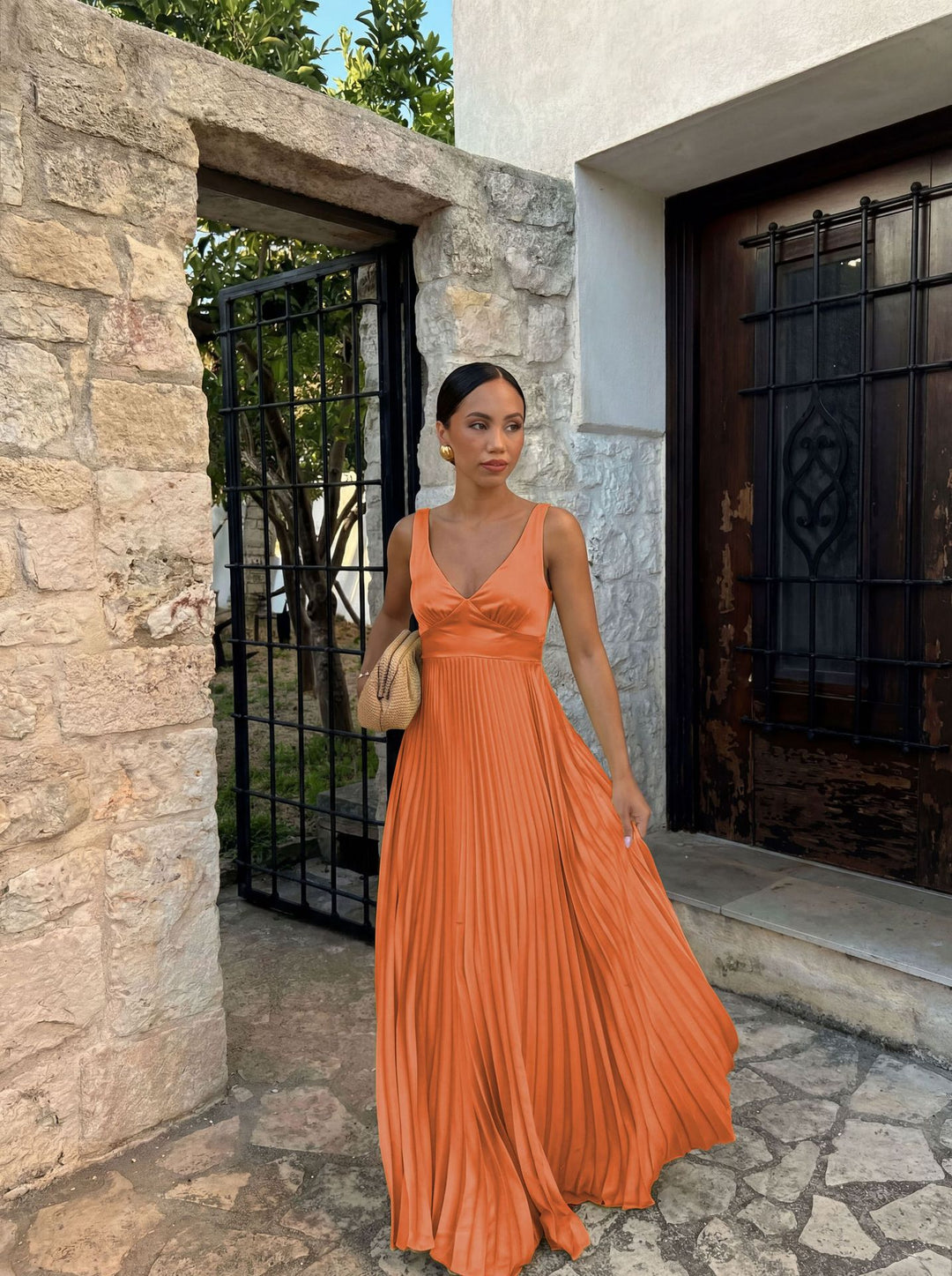Women's pleated dress with deep V-neckline and elegant silhouette