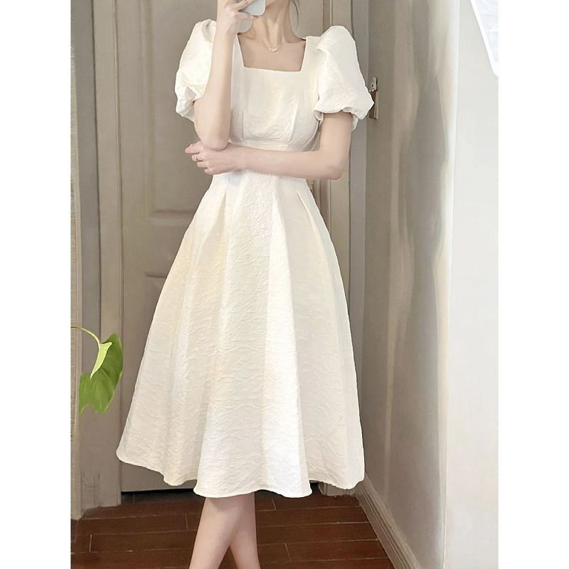 Women's elegant midi dress with square neckline and voluminous sleeves