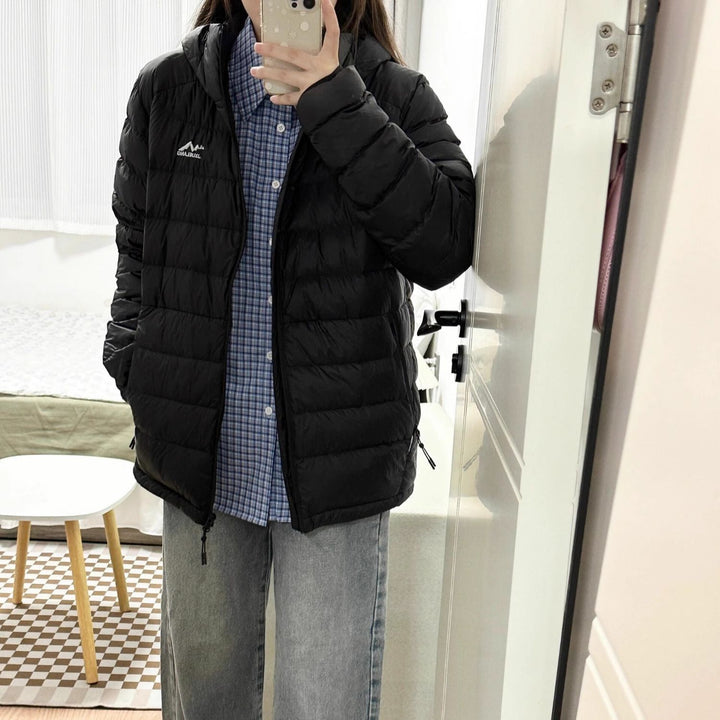 Women's quilted winter jacket with high collar and practical side pockets