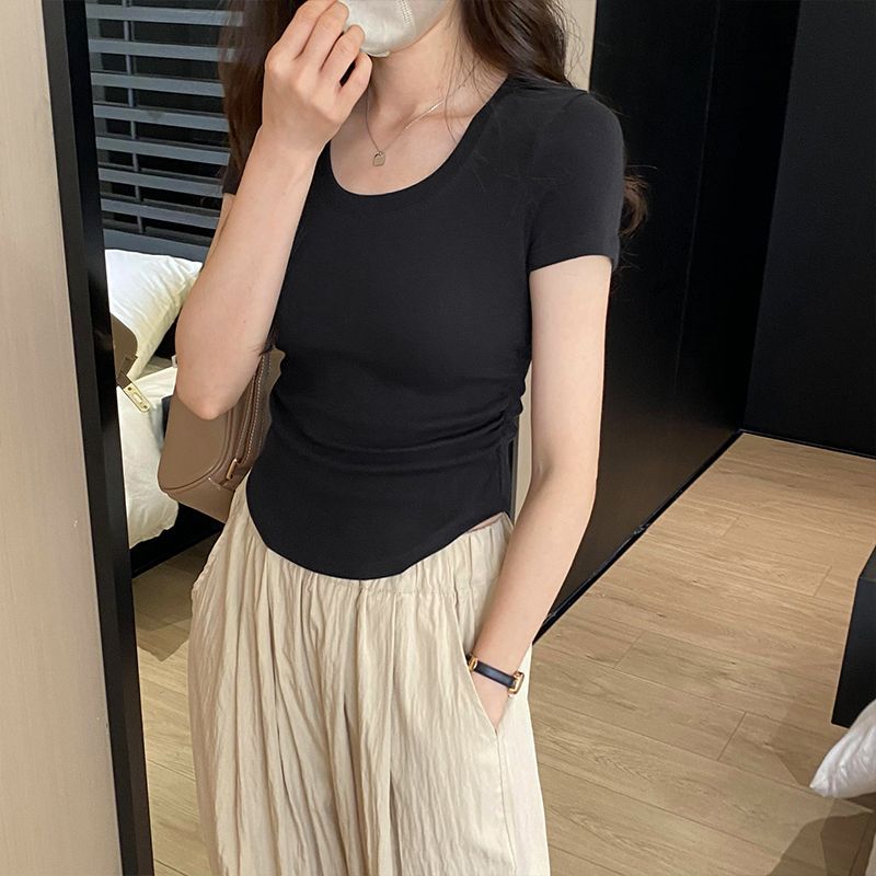 Women's fitted top with elegant round neck and delicate gathering effects