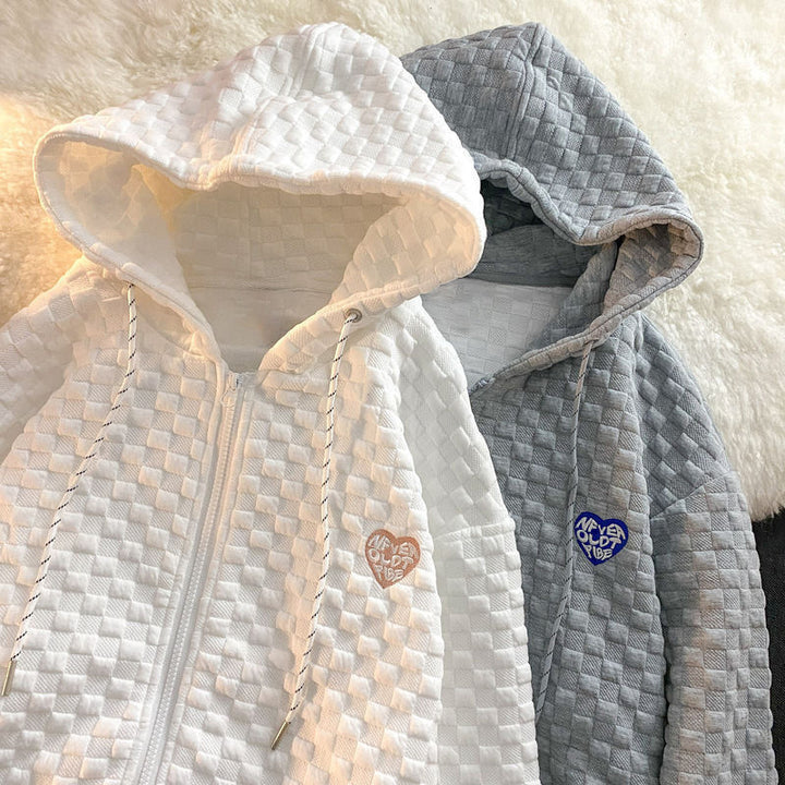 Women's hoodie jacket made of structured material with practical pockets and fashionable design