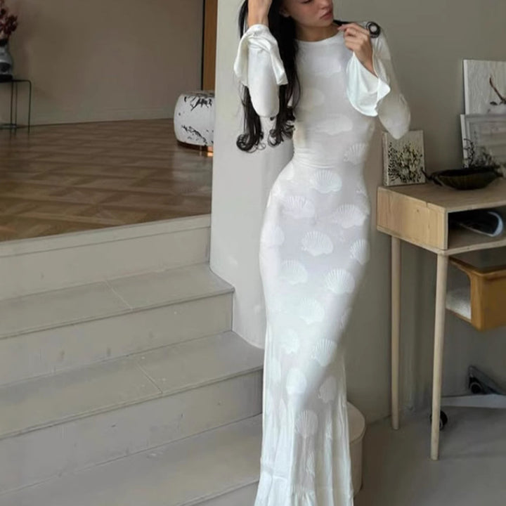 Women's form-fitting long dress with stylish shell design and elegant sleeve finish