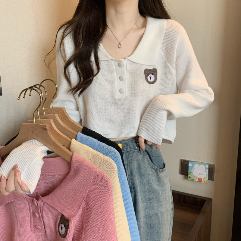 Women Cropped Pullover with a one-button closure and unicorn emblem
