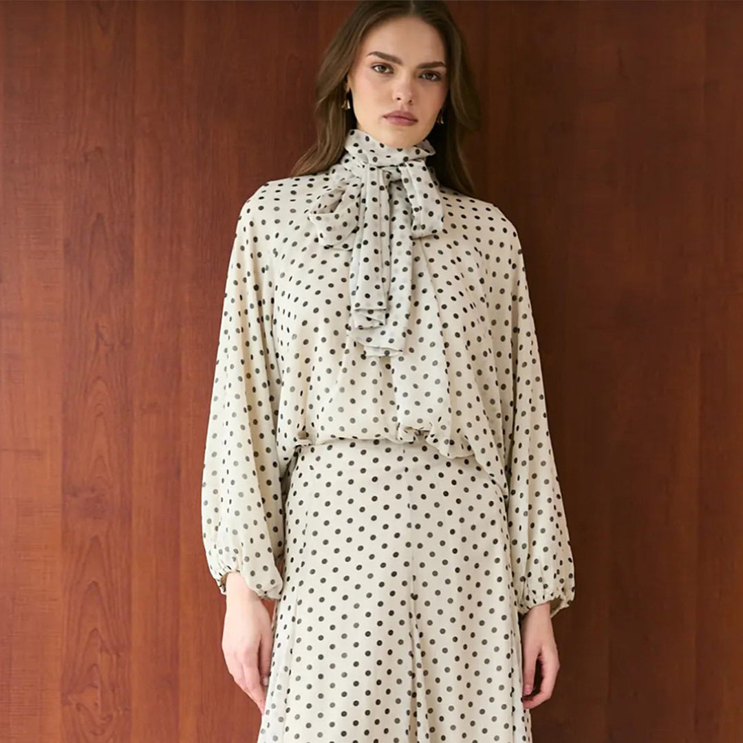 Women’s dress with elegant stand-up collar and playful polka dot design