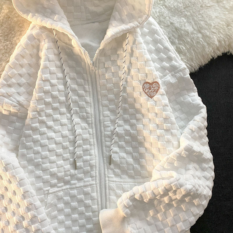 Women's hoodie jacket made of structured material with practical pockets and fashionable design