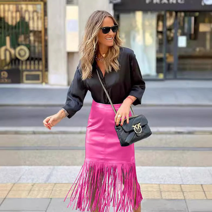 Women's fuchsia fringe skirt made of synthetic leather with a fitted silhouette and swinging design