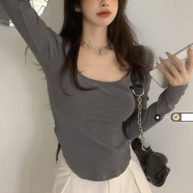 Women's long sleeve top with deep neckline and fitted silhouette