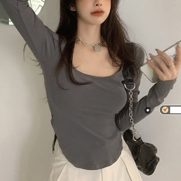 Women's long sleeve top with deep neckline and fitted silhouette