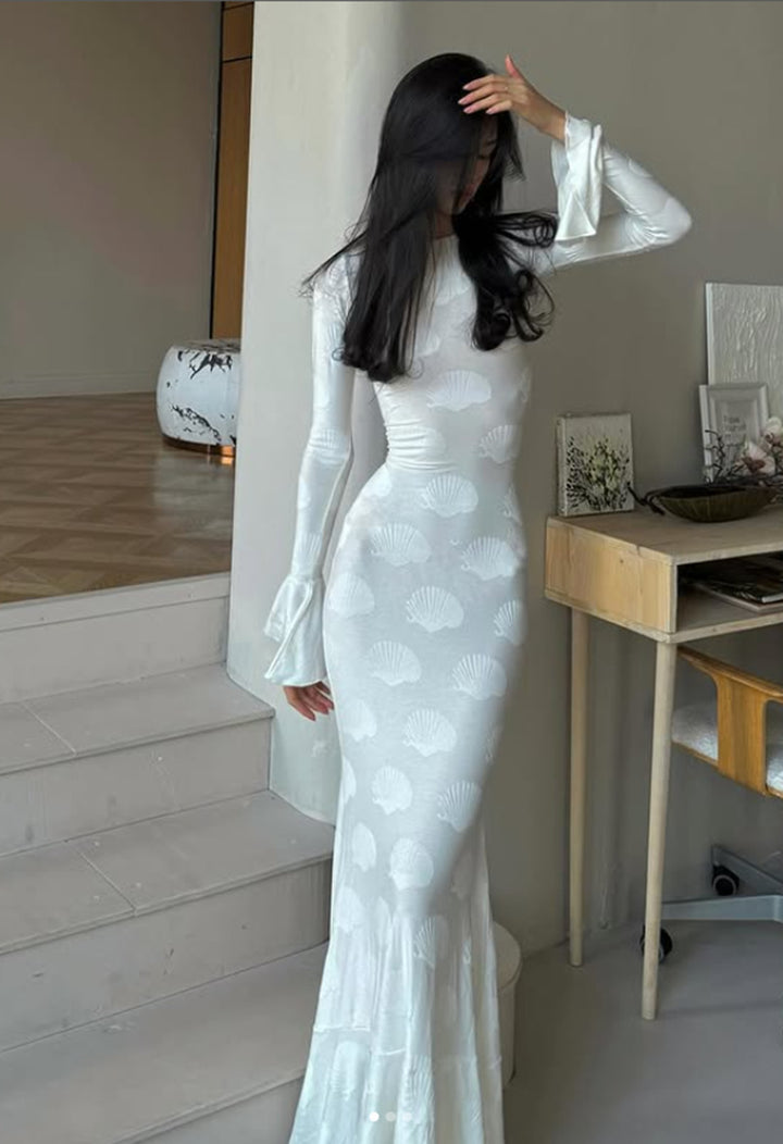 Women's form-fitting long dress with stylish shell design and elegant sleeve finish