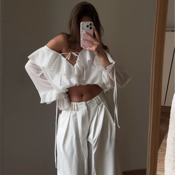 Women's blouse with voluminous ruffle details and captain sleeves