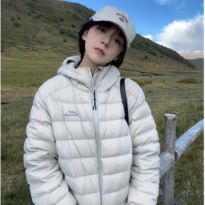 Women's quilted winter jacket with high collar and practical side pockets