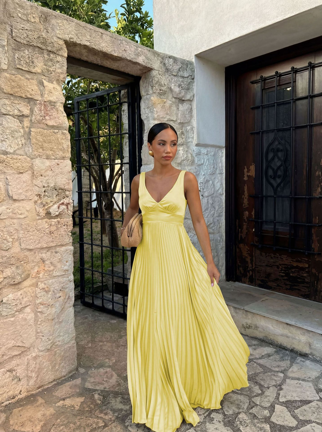 Women's pleated dress with deep V-neckline and elegant silhouette